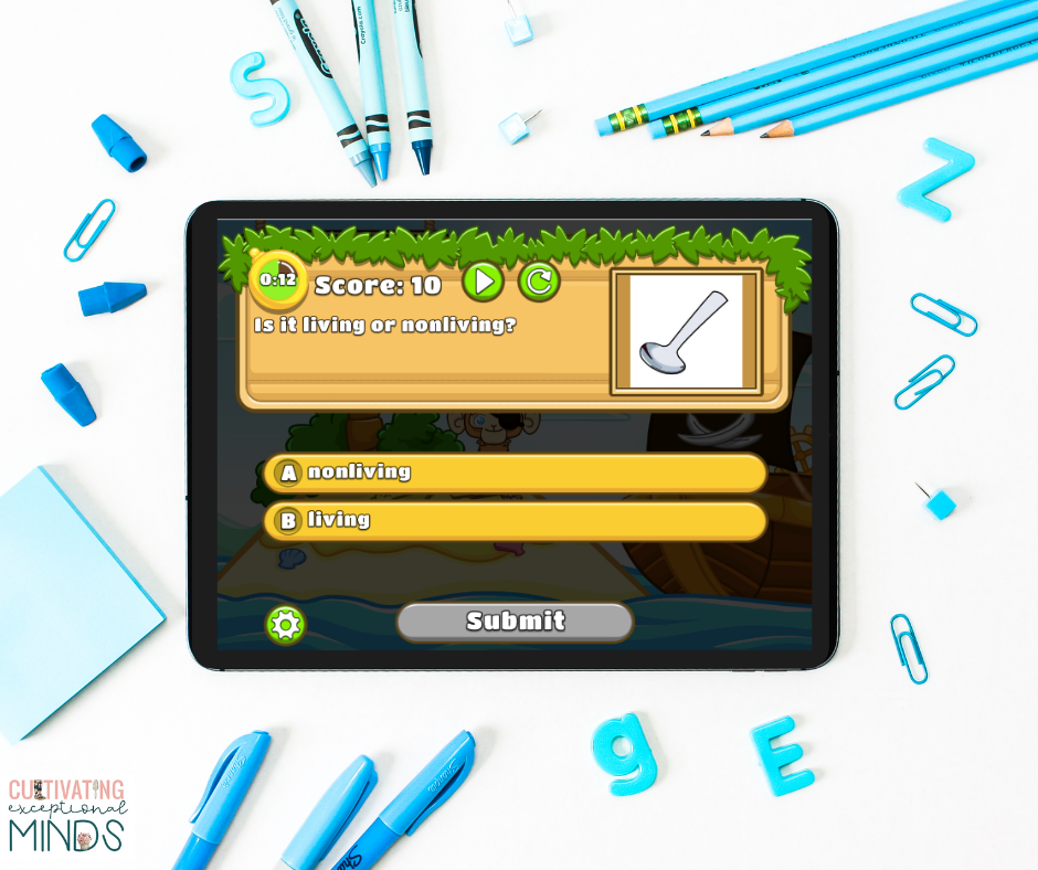 Living and nonliving computer game on an iPad surrounded by blue school supplies